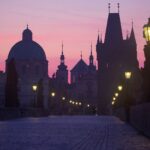 Charles Bridge in Prague at sunrise with soft golden light