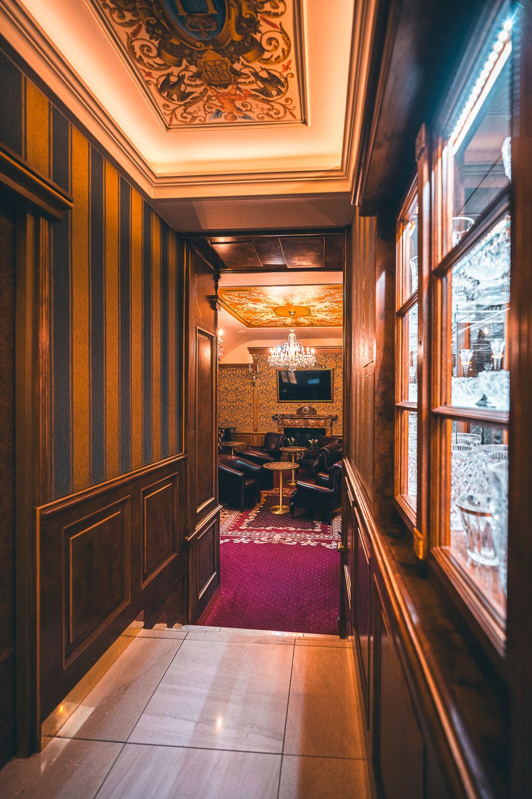 Lounge with a painted ceiling and warm lighting at Hotel Haštal Prague
