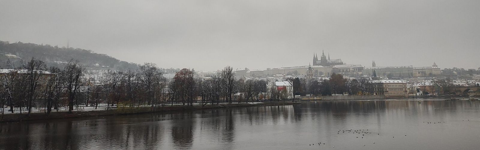 Prague Castle rising above the Vltava river, seen in panorama